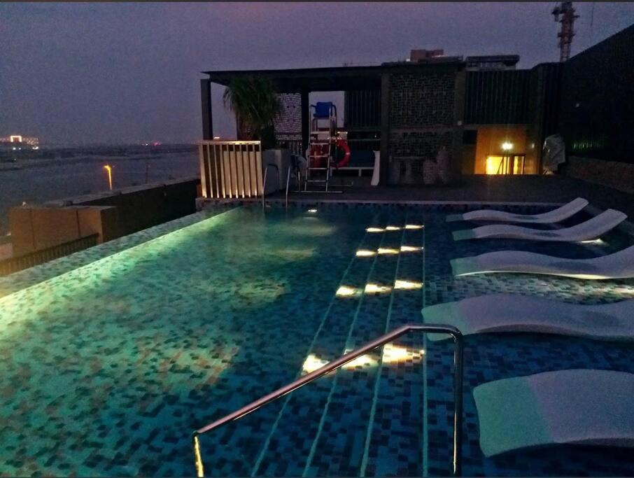 a swimming pool at night on a building at Luxurious Apartment in Dubai