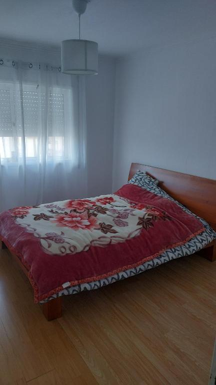 a bedroom with a bed with a red blanket at H5J - APT in Vila Nova de Gaia