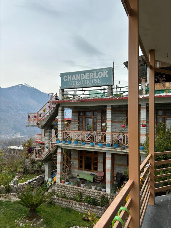 a chandan lick guest house with a mountain in the background at Naggar Manali's Paradise at Chanderlok in Nagar