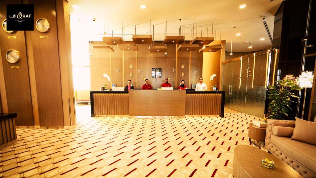 a lobby of a hotel with people sitting at a counter at AlRaef Luxury Apartments in Dubai