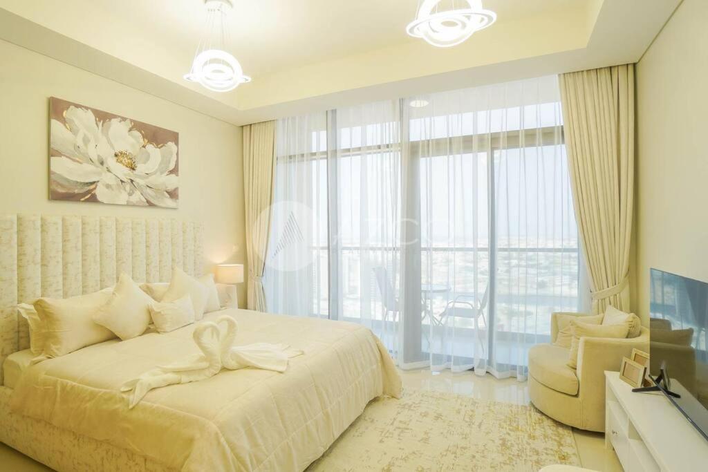 a bedroom with a large bed and a large window at Elegant Studio at Aykon City Tower - C in Dubai