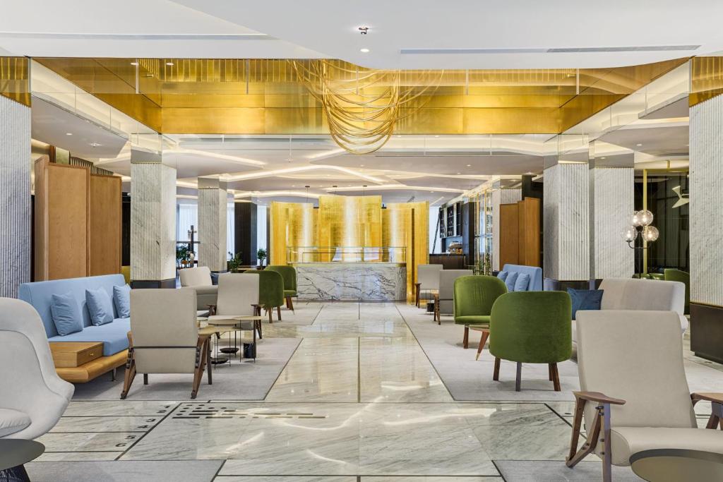 a lobby with chairs and a waiting room at Le Meridien Batumi in Batumi
