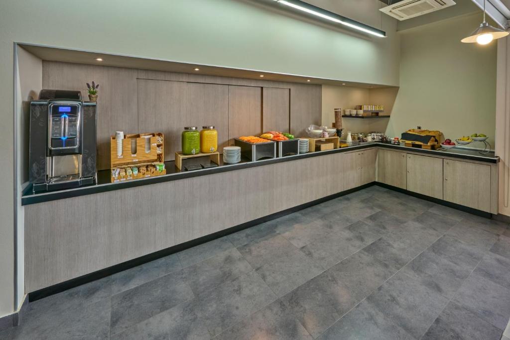 A wider view of the self-service breakfast counter and beverage station.