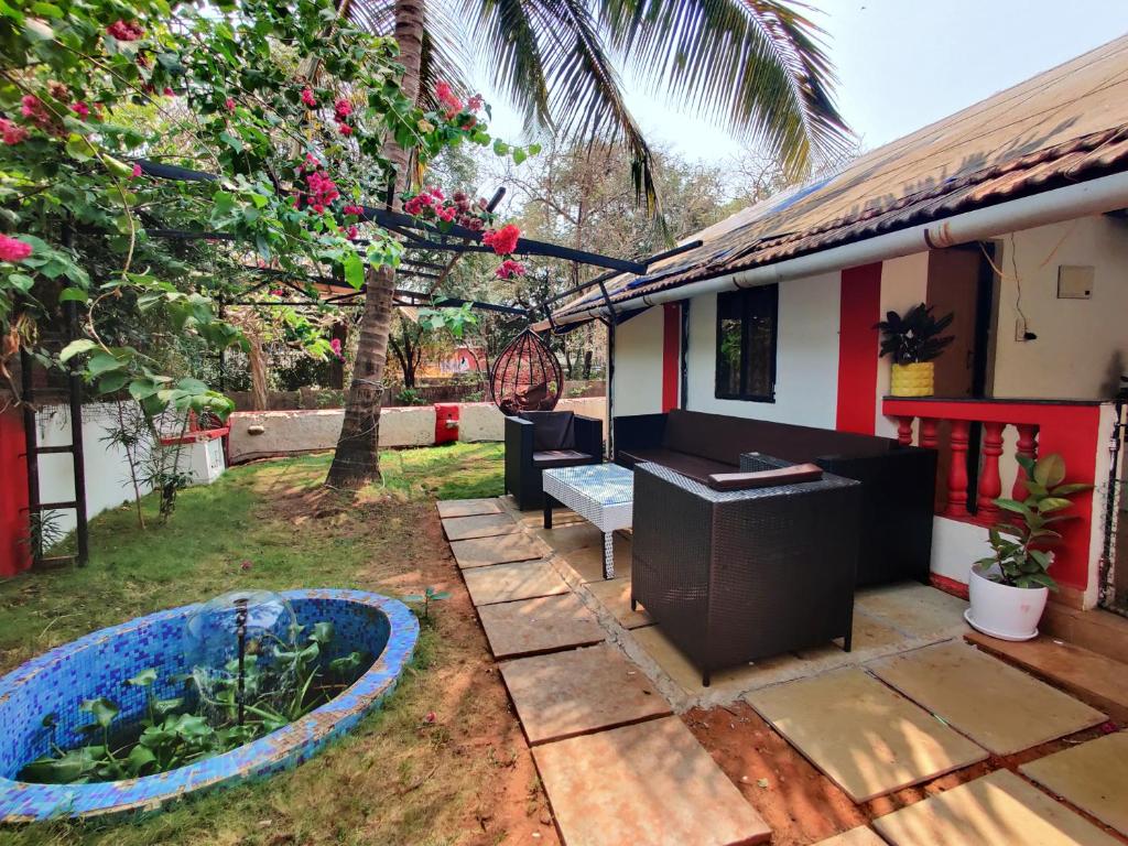 a backyard with a fish pond and a house at Mary Joey in Baga