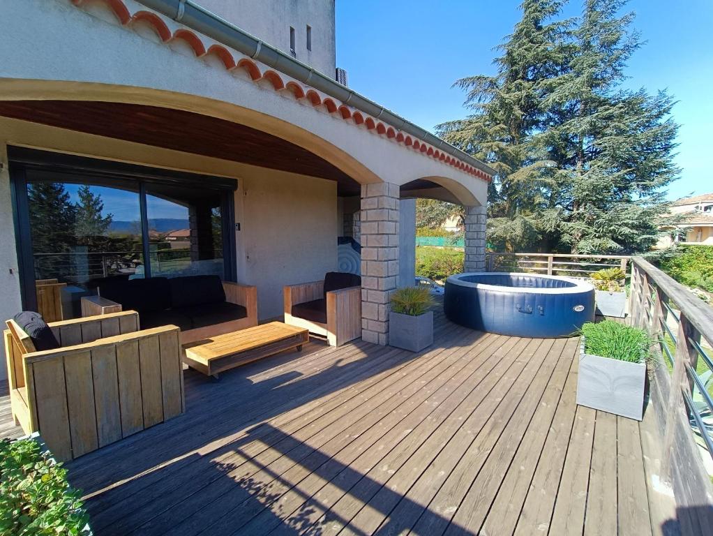 a wooden deck with a hot tub on a house at Villa Greg in Saint-Marcel-lès-Valence