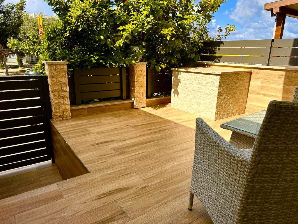 a patio with a table and chairs and trees at Athena Two-bedroom Townhouse in Paphos City