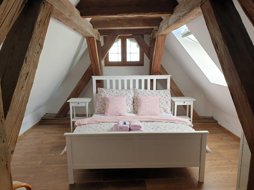 a bedroom with a white bed in a attic at Babyhotel Karolínka, wellness in Vranov nad Dyjí