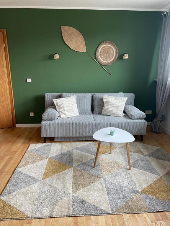 a living room with a couch and a table at Ferienwohnung in Weitersburg