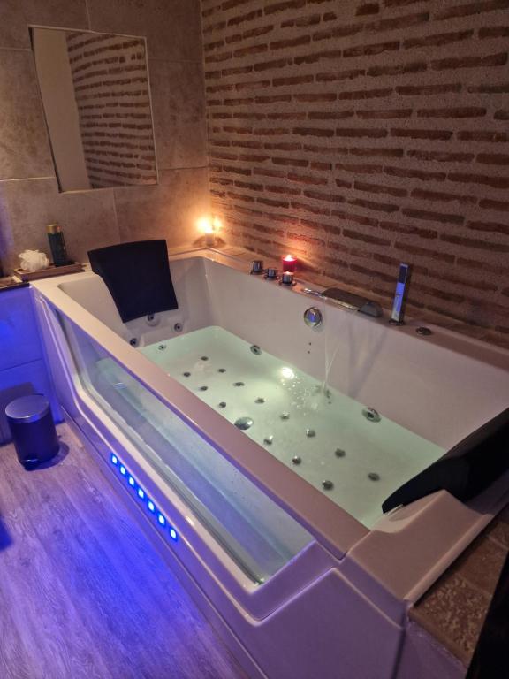 a large bath tub with at La Maison Pas'Chaaxe in Onzain