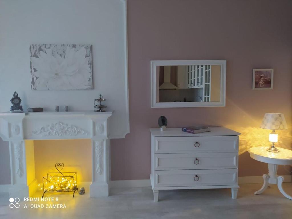 a bedroom with a white dresser and a mirror at Dream apartment in Batumi