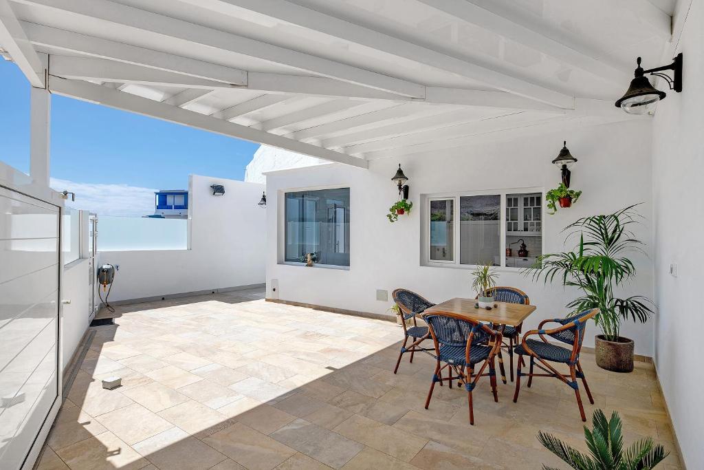 a dining room with a table and chairs on a patio at El Pasero in El Golfo