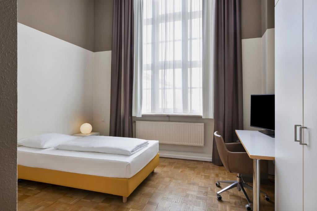 Postel nebo postele na pokoji v ubytování Gästeresidenz PelikanViertel