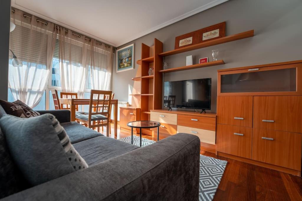 a living room with a couch and a flat screen tv at Elegante Espacio Residencial in Santa Cruz de Bezana