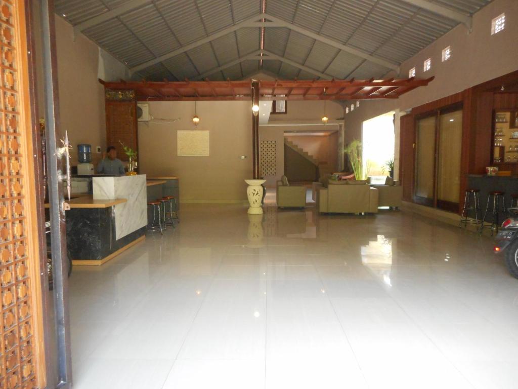 a large room with a kitchen and a living room at Suci Amerta Guest House in Menanga