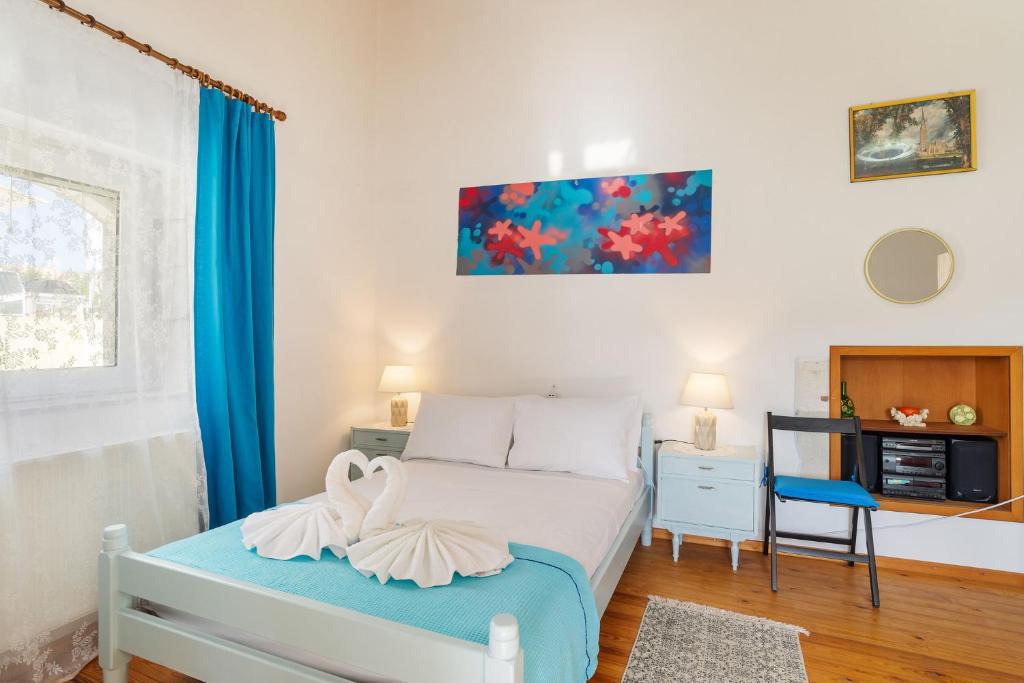 a bedroom with a bed with two towels on it at Andreas Guest House in Gavalochori