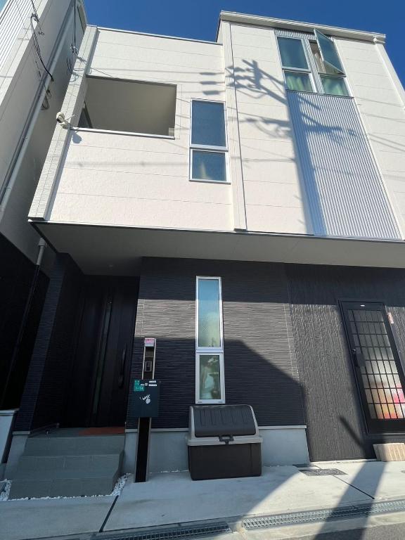 a building with a bench in front of it at 一期一会Ⅱ in Osaka
