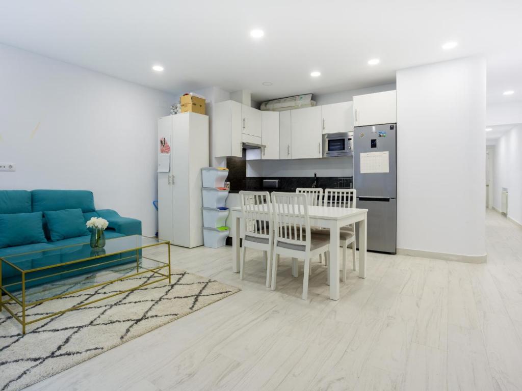 a living room with a table and a blue couch at 18 Beautiful Costa Rica Apartment Madrid in Madrid
