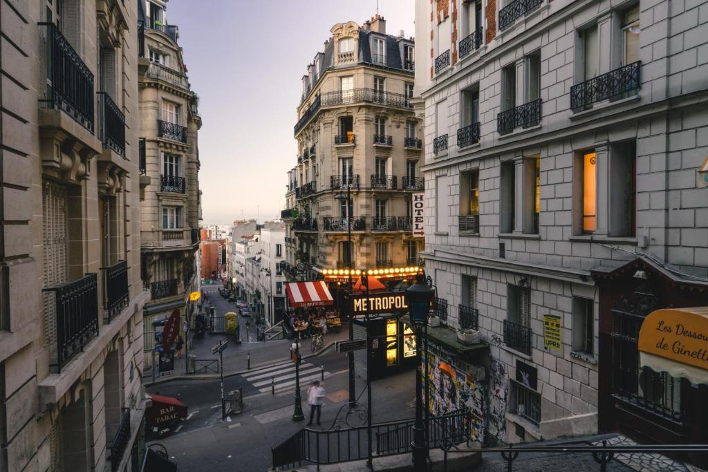 a view of a city street with tall buildings at St Germain des Pres with Balcony - CityApartmentStay in Paris