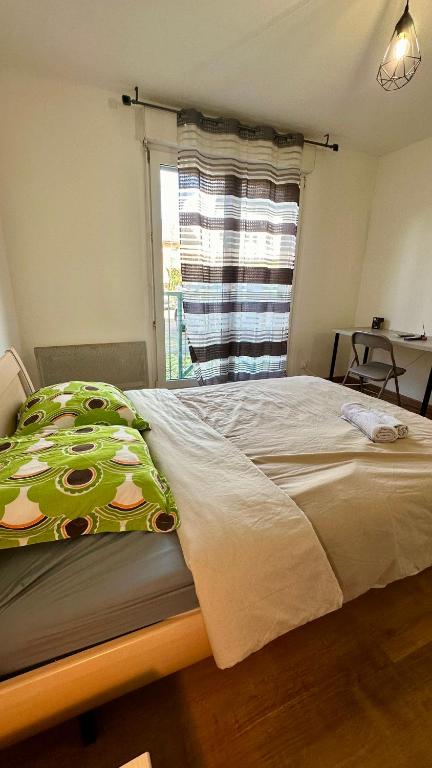 a bedroom with a large bed with a window at Sublime studio en hypercentre avec parking privé 8 in Mulhouse