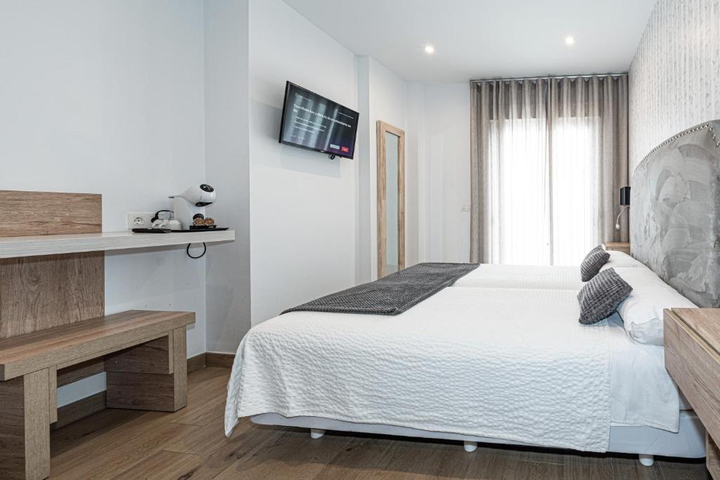Posteľ alebo postele v izbe v ubytovaní Hostal Boutique Aurora