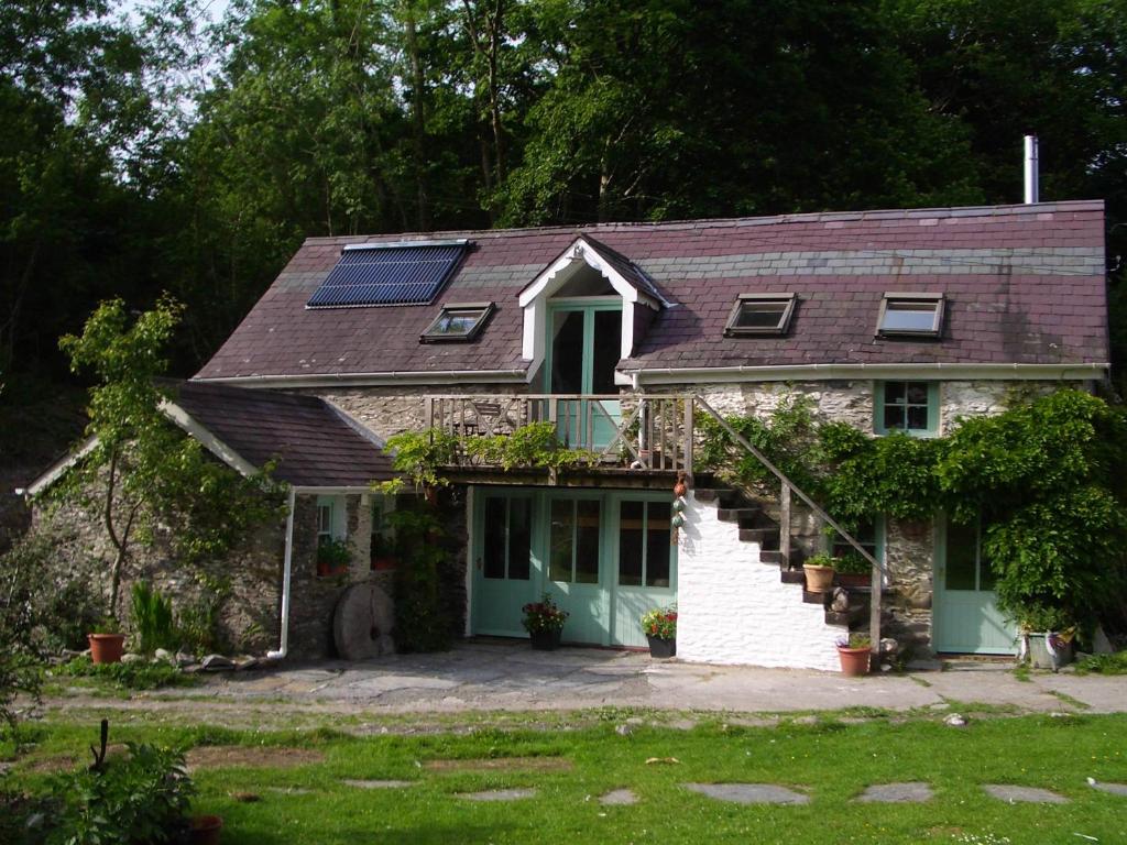 a house with a solar panel on the roof at The Old Mill Devils Bridge in Llanilar
