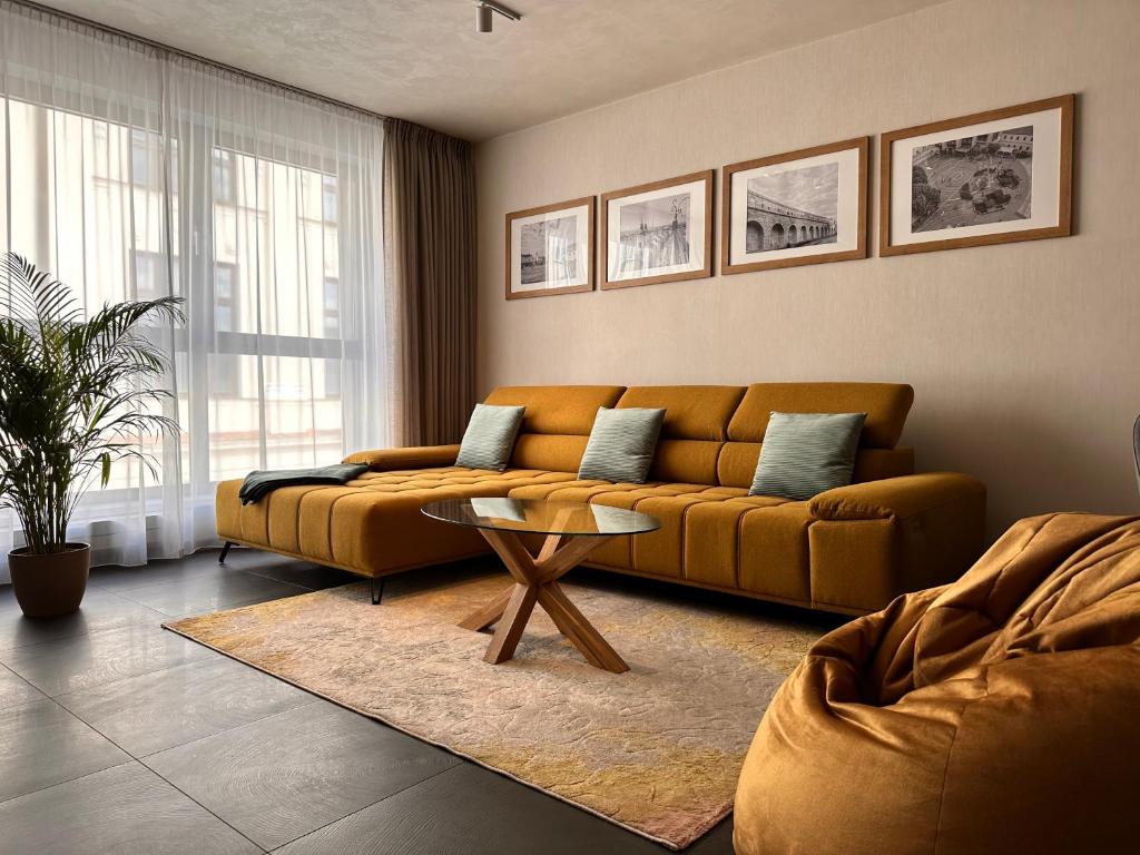 a living room with a couch and a table at Apartmán Leonardo - city center in Trnava