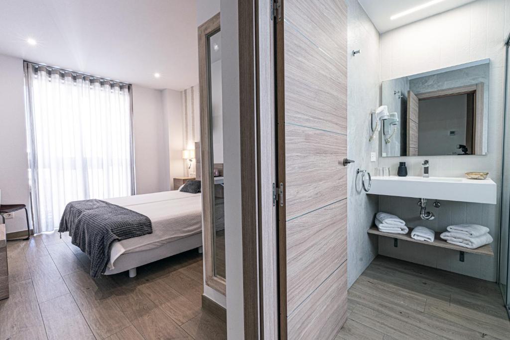 Posteľ alebo postele v izbe v ubytovaní Hostal Boutique Aurora