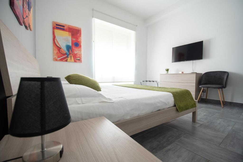 Łóżko lub łóżka w pokoju w obiekcie Casa Vacanze Family House posizione centralissima