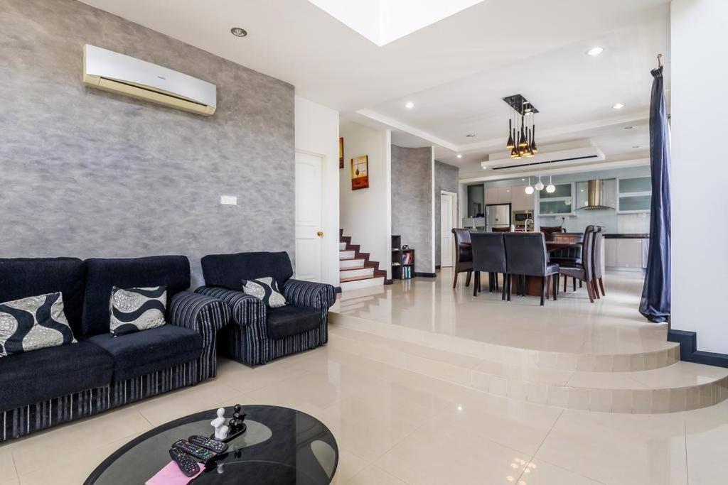 a living room with a couch and a dining room at Duplex Condominium In Bukit Bintang For Rent in Kuala Lumpur