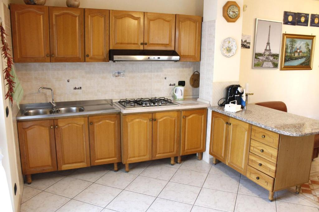 a kitchen with wooden cabinets and a sink and a stove at Casa Marinella in Agerola