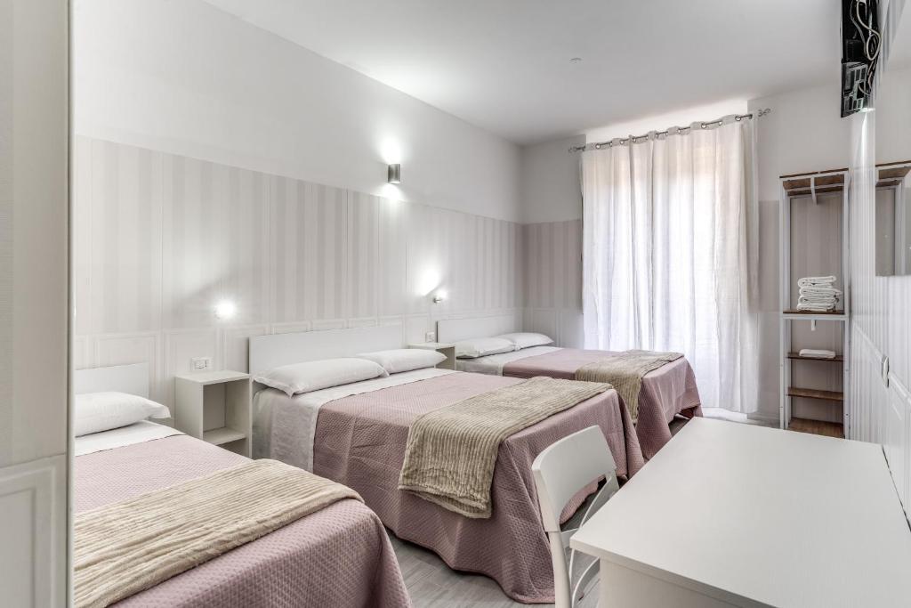 a hospital room with three beds in it at AltaDomus Roma in Rome