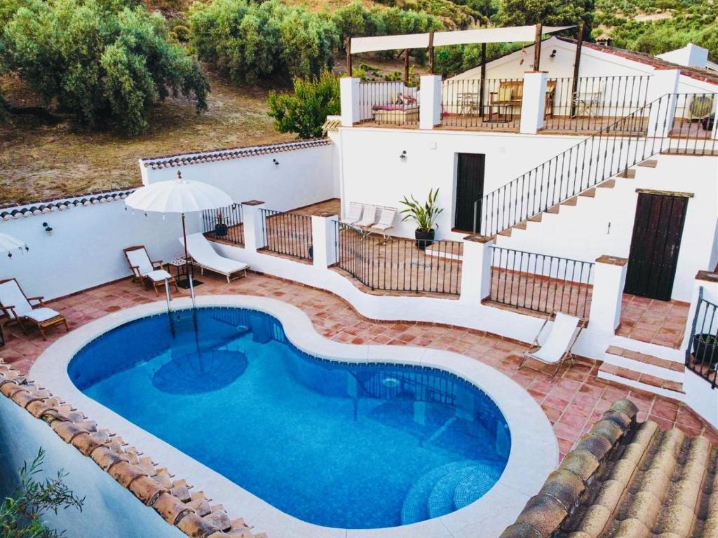 an image of a swimming pool with a house at Valle de Oro in Villanueva de Algaidas