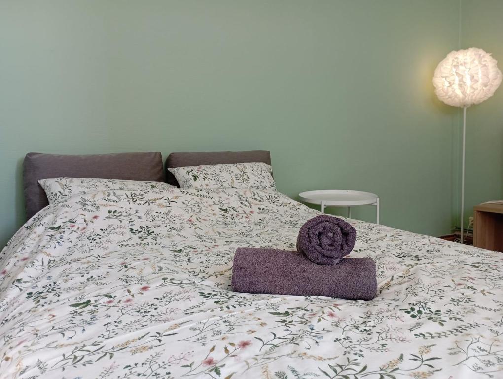 a bed with a purple towel on top of it at Révélation Liège in Liège