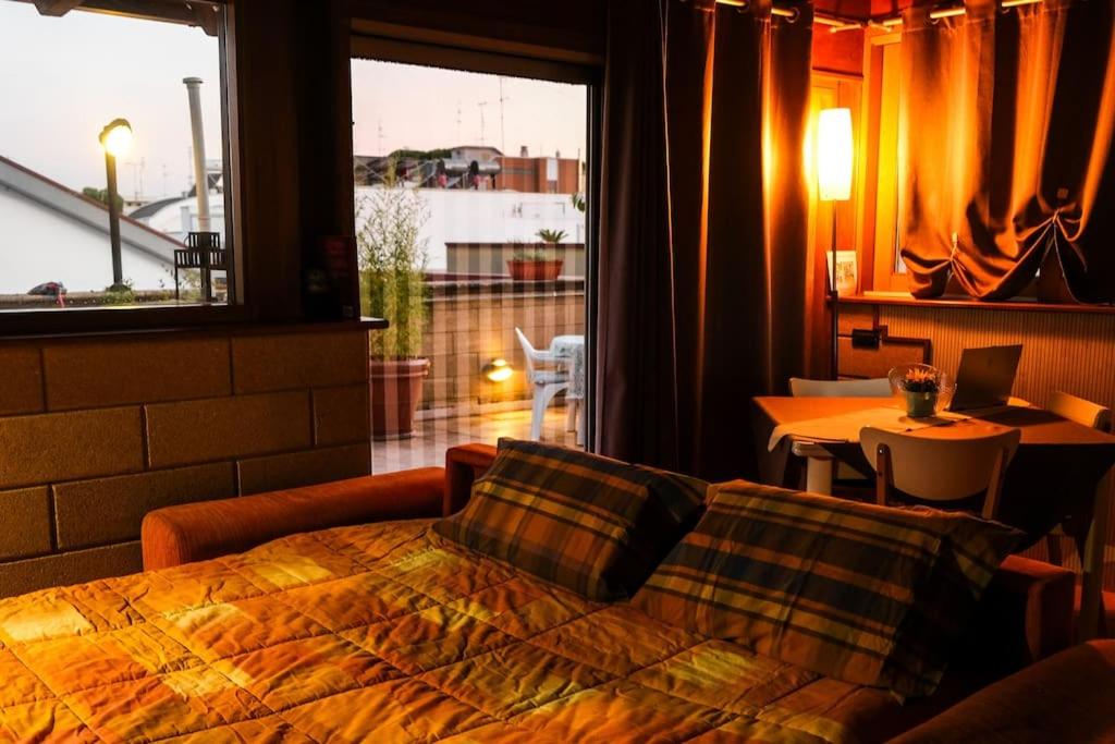 a bedroom with a bed and a large window at Attico Oasi di Relax Adelfia in Adelfia