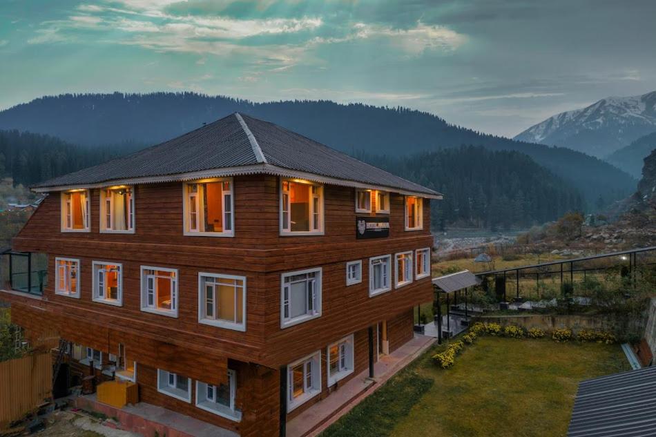 a large wooden house with windows and a balcony at Marina Drung Waterfall By Stay Pattern in Gulmarg