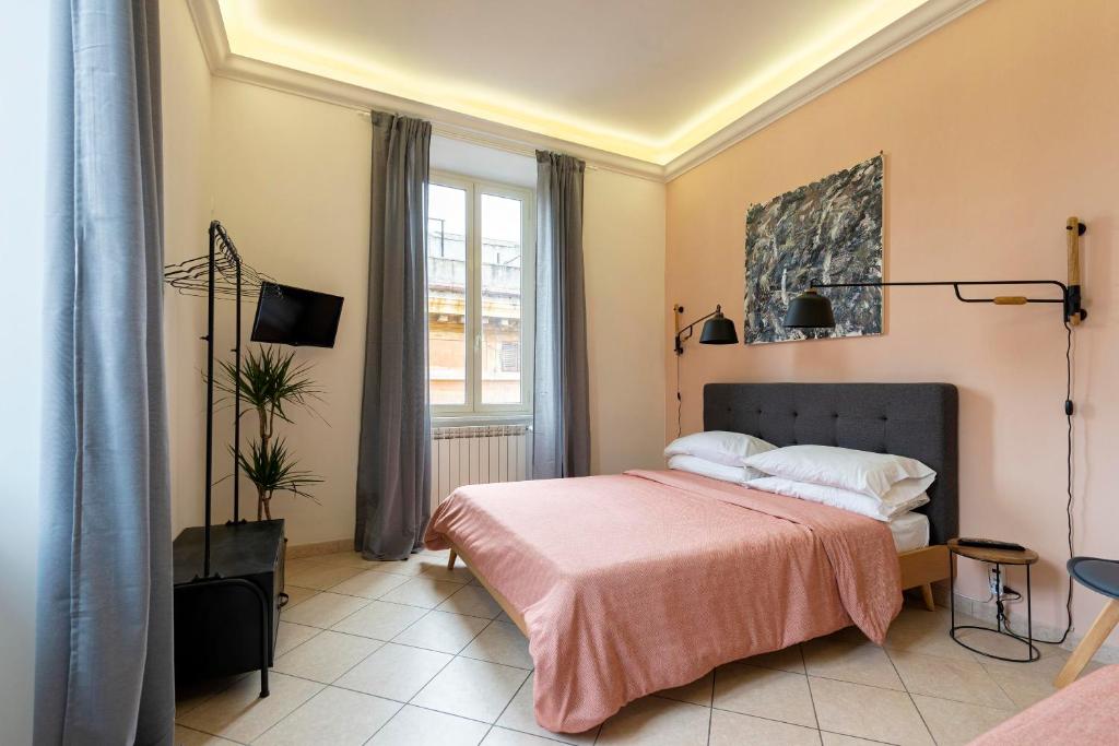 Posteľ alebo postele v izbe v ubytovaní Redseven Rome Apartments