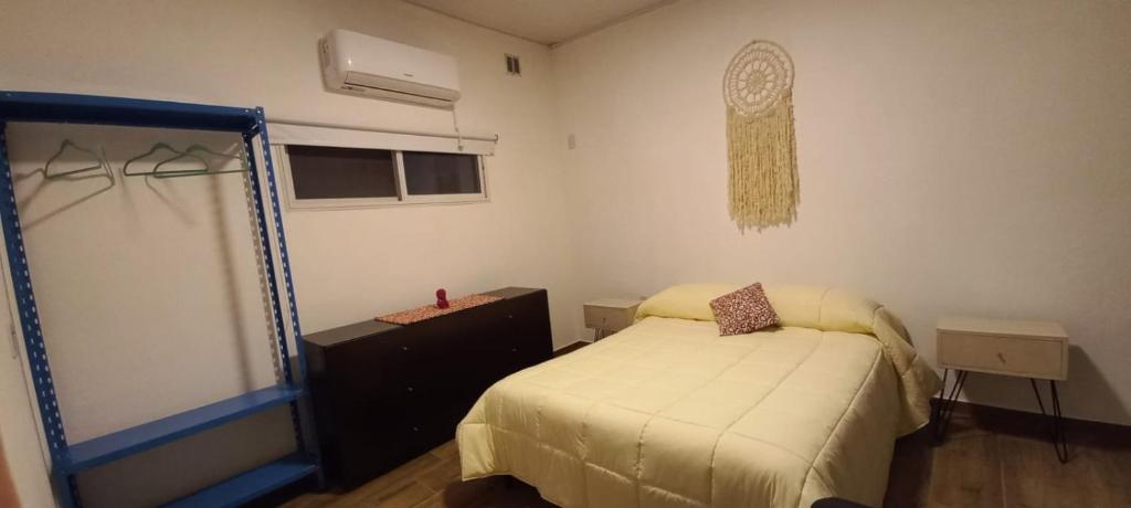 a small bedroom with a bed and a window at Casa - Departamento - Loft in Concepción del Uruguay