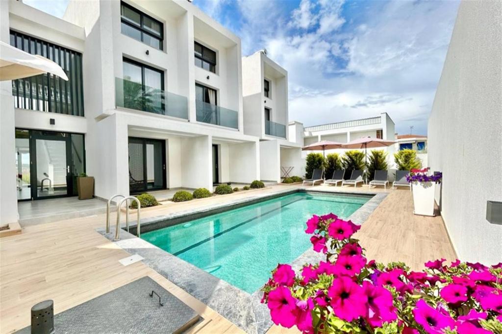 an image of a house with a swimming pool at White Lion Apartment N2 Kallithea in Kallithea Halkidikis