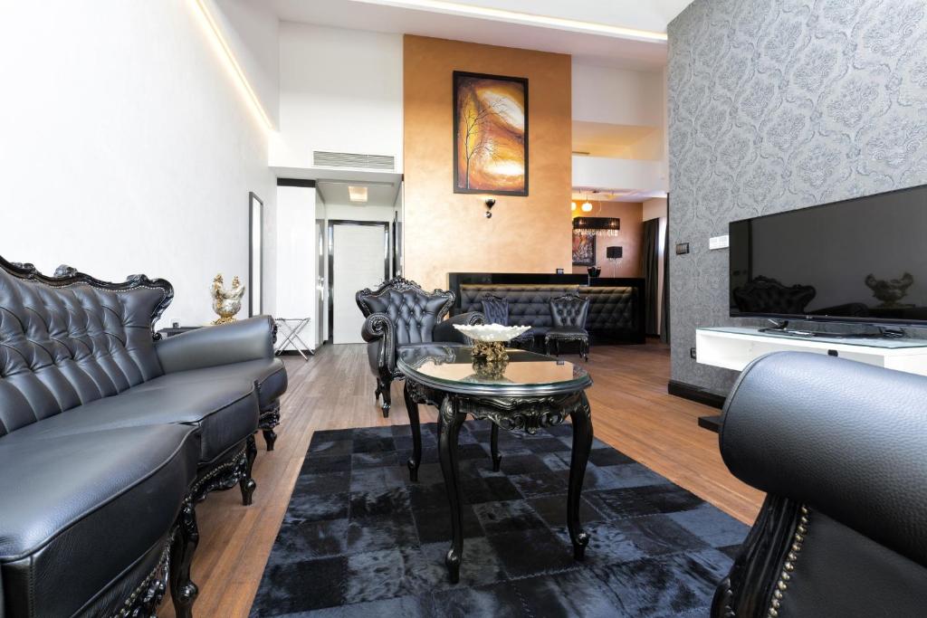 a living room with a couch and a table at Nova City Garni Hotel Signature Collection in Belgrade