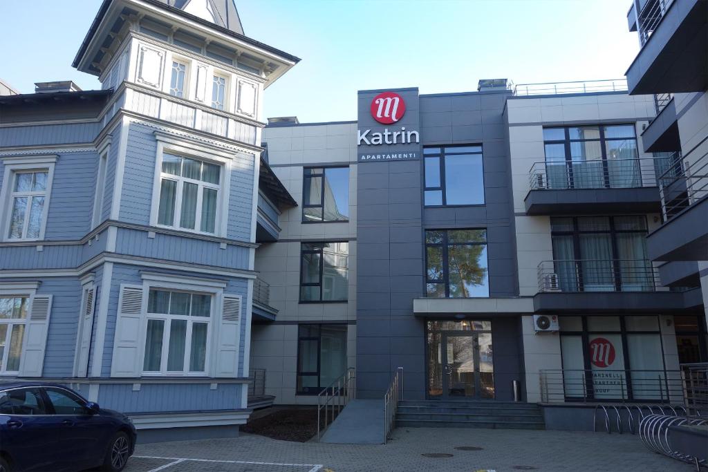 a building with a kishi sign in front of it at Katrin Apartments in Jūrmala