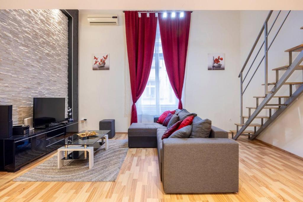 a living room with a couch and a tv at Marianna apartment in Budapest