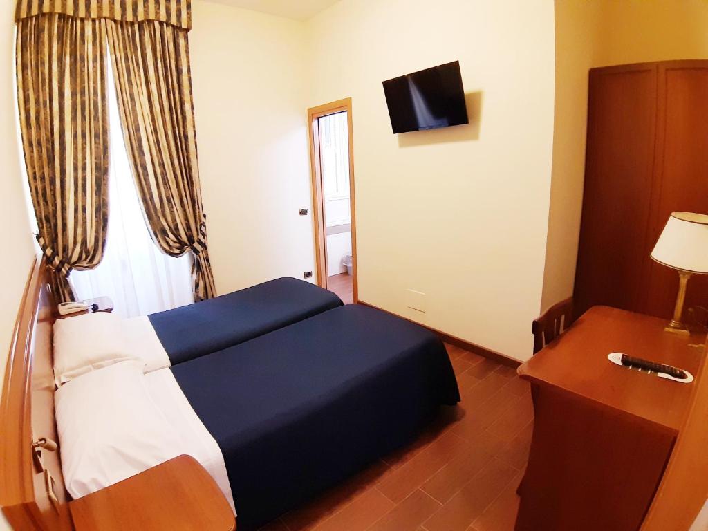 Postel nebo postele na pokoji v ubytování Hotel Mariano