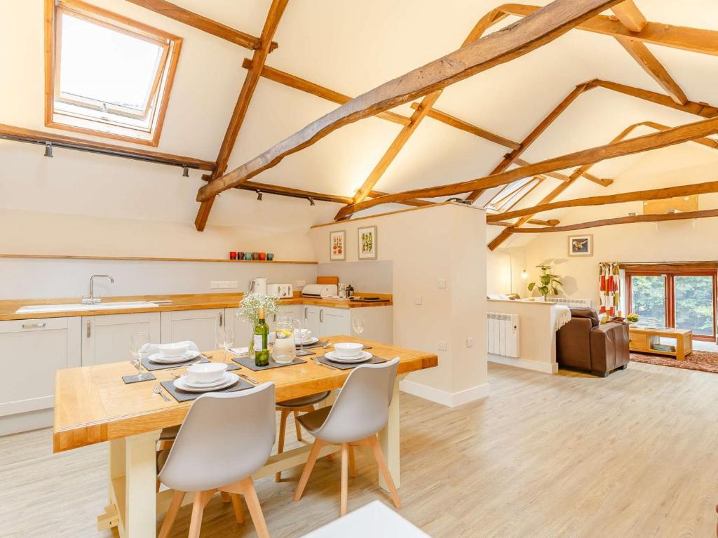 a kitchen and dining room with a wooden table and chairs at 2 Bed in Umberleigh 88605 in Chittlehampton