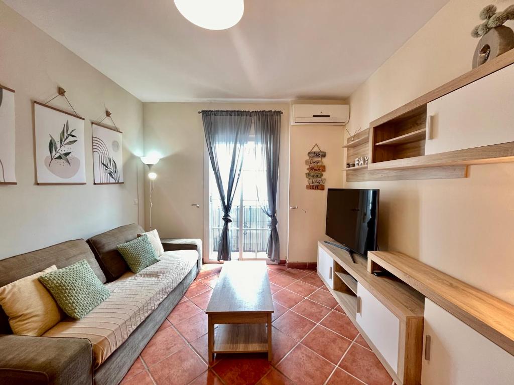 a living room with a couch and a tv at El Muro in Benalmádena