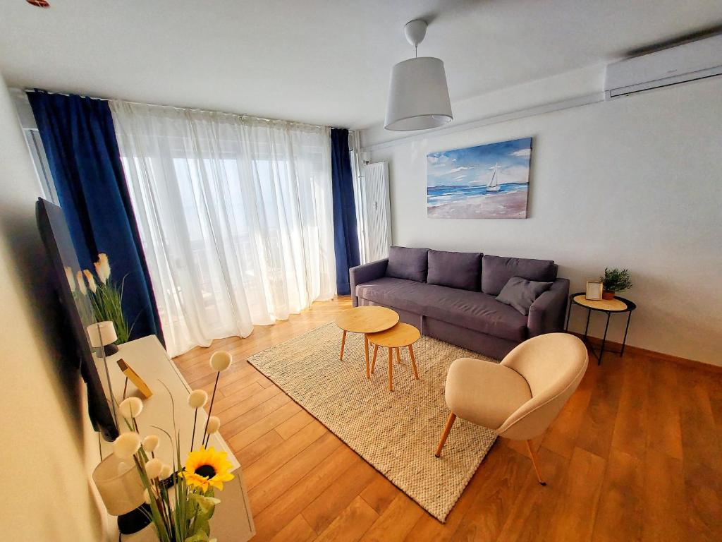 a living room with a couch and a table at Sunflower Sky Apartment in Rijeka