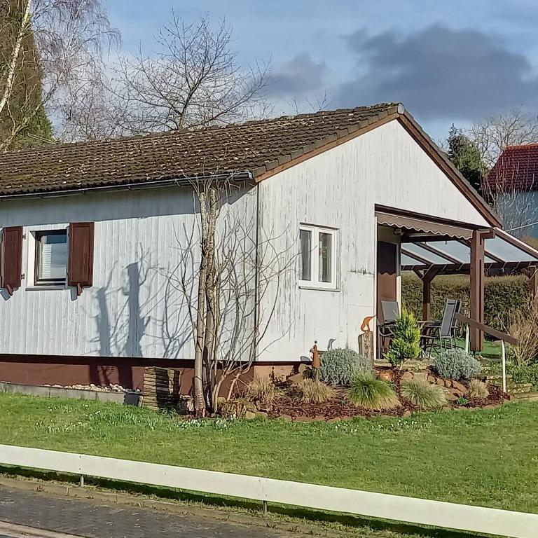 a small white house with a porch at Landhaus Westrich in Walldürn