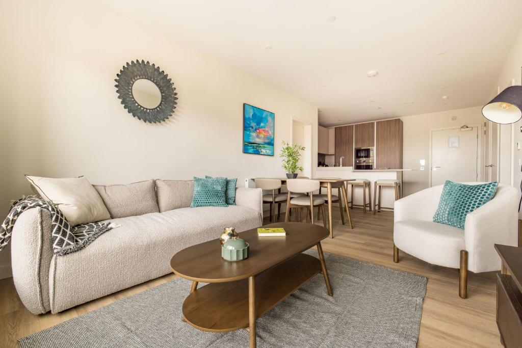 a living room with a couch and a table at London Greenford by Charles Hope in Greenford