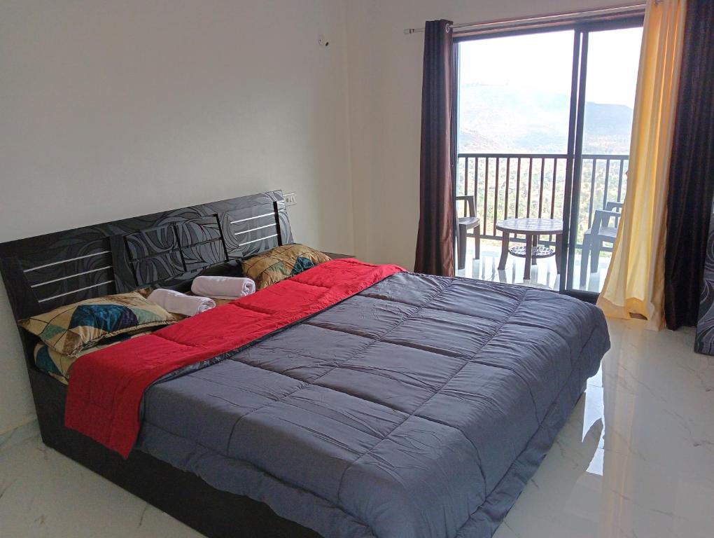 a dog laying on a bed in a bedroom with a balcony at Western Valley Cottages , Panchagani in Panchgani