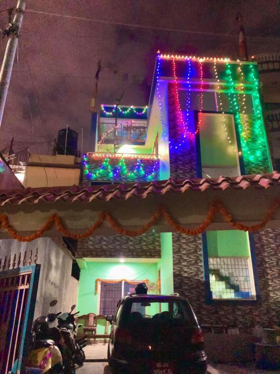 a house with christmas lights on the side of it at Swoyambhu Home Stay in Kathmandu