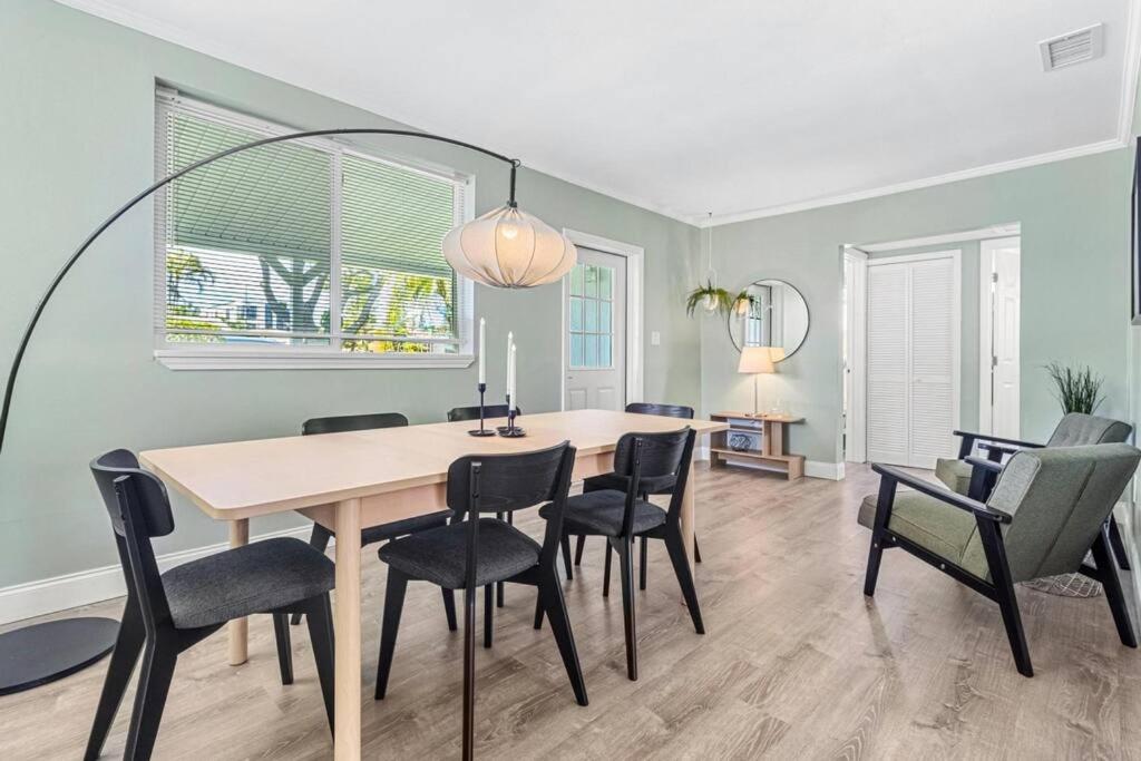 a dining room with a table and chairs at Stylish Bungalow Steps to Beach! in St. Pete Beach